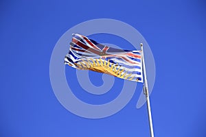 Beautiful British Columbia flag over summer blue sky