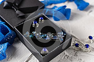 Beautiful brooch with blue and aquamarine stones and rhinestones of different sizes, metal base pins in a gift box with a black bo