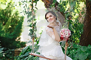 Beautiful brunette bride with bouquet outdoor. Happy bride outdo