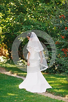 Beautiful brunette bride with bouquet outdoor. Happy bride outdo