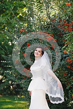 Beautiful brunette bride with bouquet outdoor. Happy bride outdo