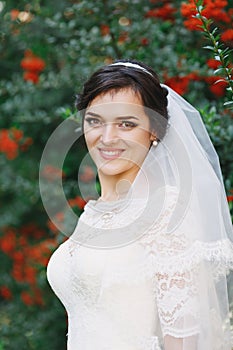 Beautiful brunette bride with bouquet outdoor. Happy bride outdo