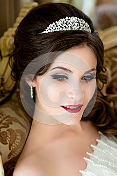 Beautiful brunette Bride portrait wedding makeup and hairstyle with diamond crown