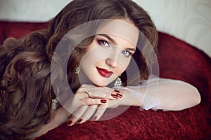 Beautiful brunette bride woman. Wedding Makeup. Red manicured na