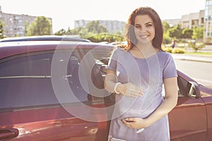 Beautiful brunette caucasian pregnant woman on summer walk outdo