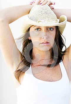 Beautiful brunette cowgirl with freckles.