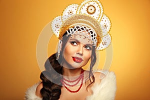 Beautiful brunette fashion woman portrait in fur coat and kokoshnik (woman's headdress in old Russia).