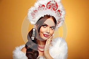 Beautiful brunette fashion woman portrait in fur coat and kokoshnik (woman's headdress in old Russia).