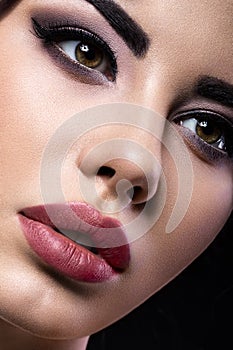 Beautiful brunette girl with arabic evening make-up and perfect skin. Beauty face. Close up