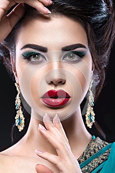 Beautiful brunette girl with arabic evening make-up and perfect skin. Beauty face. Close up