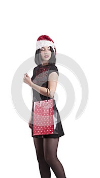 Beautiful brunette girl attractive in santa braces hat shopping bag