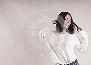 Beautiful brunette girl braces happy white sweater, dancing, emotion