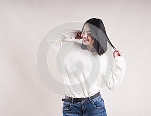 Beautiful brunette girl braces happy white sweater,holiday dancing, emotion