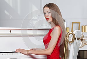 Beautiful brunette girl in a fashionable evening dress. Red lips. Studio shot