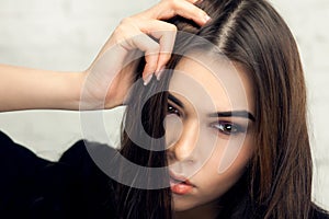 Beautiful brunette girl with hair curled tail