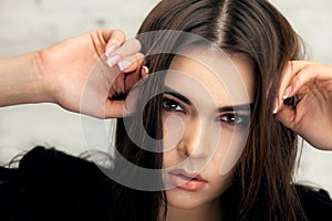 Beautiful brunette girl with hair curled tail