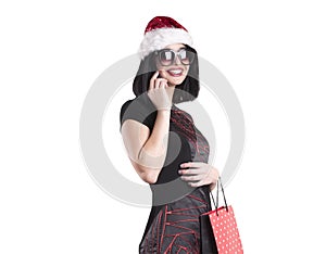 Beautiful brunette girl in santa winter surprise wearing black glasses with phone