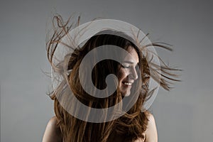 Beautiful brunette girl with windy hair