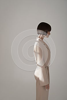 Beautiful brunette with graphic bob haircut wear beige fashion pantsuit