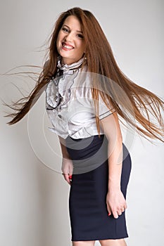 Beautiful brunette hair motion freeze isolated over white. Studio shot, vertical image