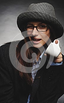 Beautiful brunette with hat and glasses posing in studio in various positions and industry-specific representations photo stock. photo
