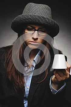 Beautiful brunette with hat and glasses posing in studio in various positions and industry-specific representations photo stock.