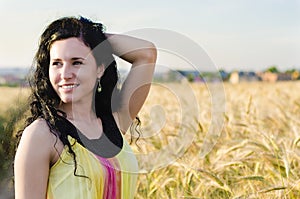 Beautiful brunette lady in wheat field