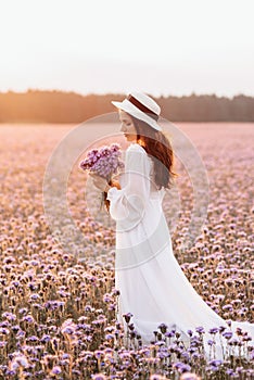 Beautiful brunette in a lavender field at sunset Amazing Portrait