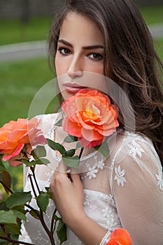 Beautiful brunette with orange rose