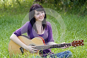 Beautiful Brunette Outdoors with a Guitar (1)