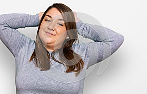 Beautiful brunette plus size woman wearing casual clothes doing bunny ears gesture with hands palms looking cynical and skeptical