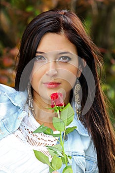 Beautiful brunette with red rose