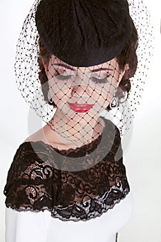 Beautiful brunette retro woman portrait in elegant hat with red