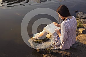 Beautiful brunette senior woman studying for her exams sitting o