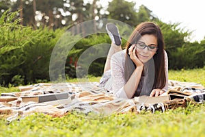 Beautiful brunette senior woman studying for her exams sitting o