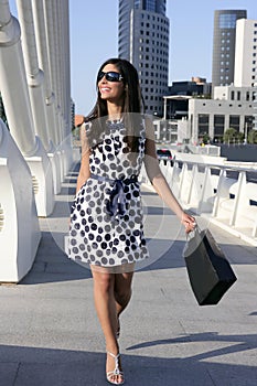 Beautiful brunette shopaholic outdoor city photo