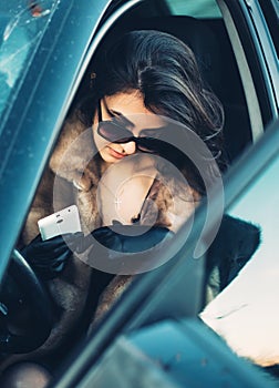 Beautiful brunette sitting in the car