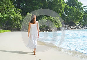 Beautiful brunette walking among the seacoast