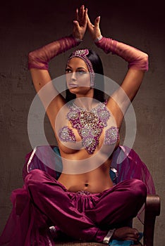 Beautiful brunette woman in afghani pants, purdah and adornment photo