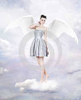 Beautiful brunette woman as angel in heaven