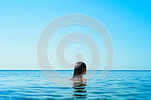 Beautiful brunette woman on the beach