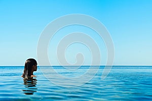 Beautiful brunette woman on the beach