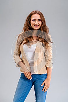 Beautiful brunette woman in a beige jacket