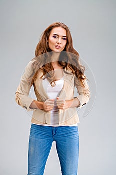 Beautiful brunette woman in a beige jacket