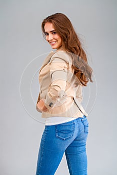 Beautiful brunette woman in a beige jacket