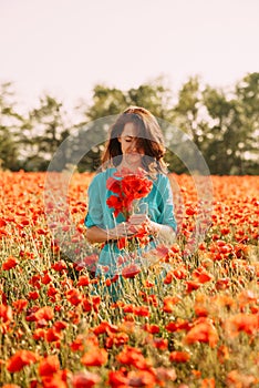 Beautiful brunette woman with bouquet of poppies.