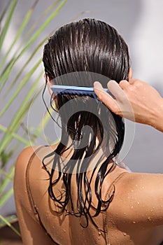 Beautiful Brunette Woman Brushing Her Wet Hair