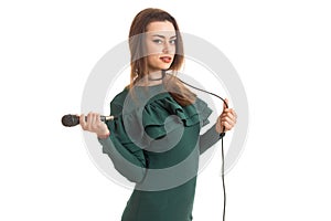 Beautiful brunette woman in elegnat green dress with microphone