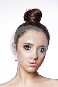 Beautiful Brunette Woman with Fashion Makeup and Bun Hairstyle. Celebrate Style Eye Make-up. Bright Fashion Look