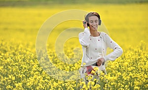 Beautiful brunette woman girl listening to music in headphone